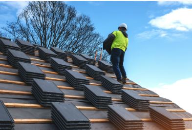Roof repair specialist working on a tiled roof in Worcestershire
